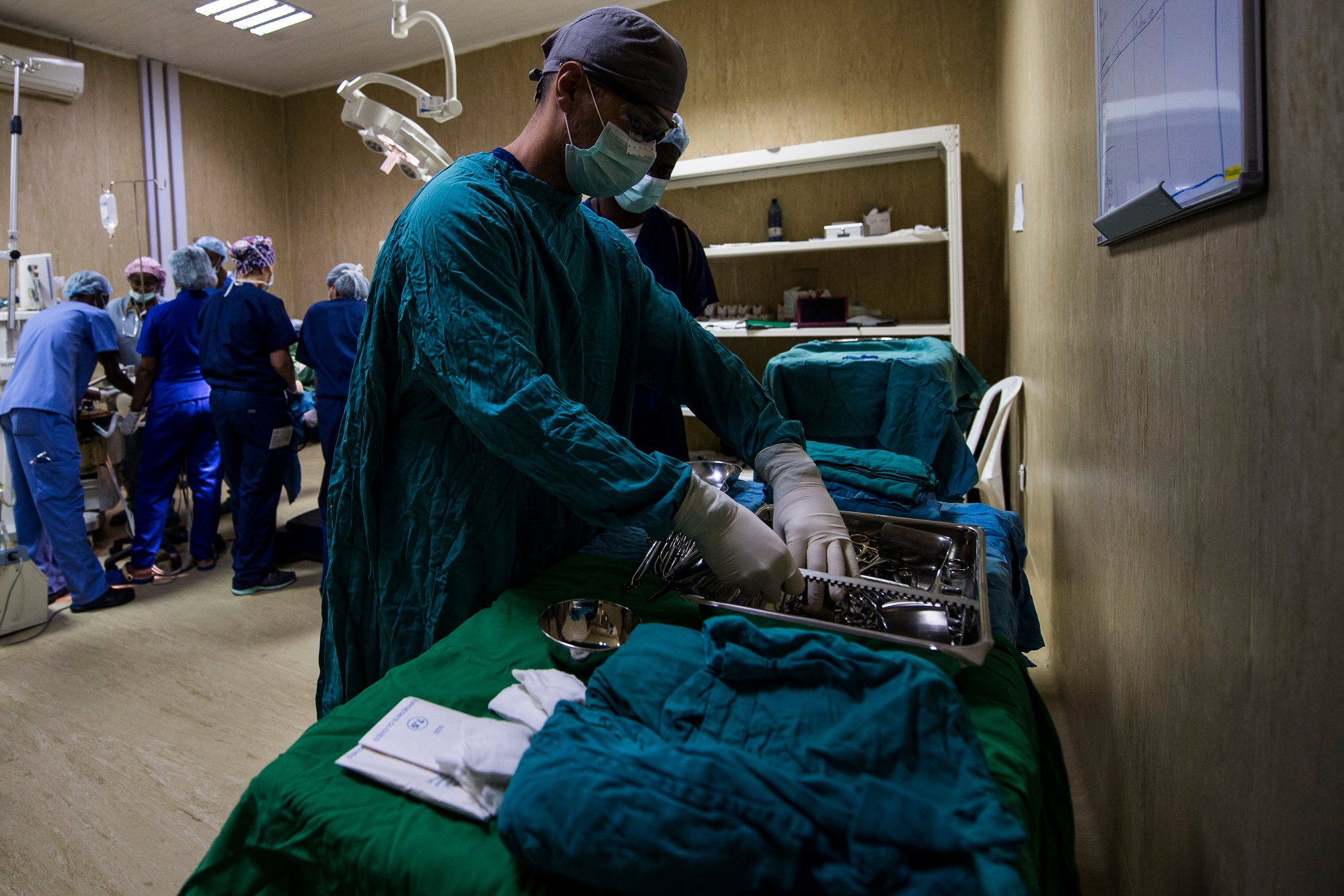 Operating room — surgical team preparing instruments